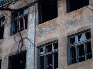 broken Windows after the bombing and fire. airstrike. broken Windows. abandoned areas of military operations.