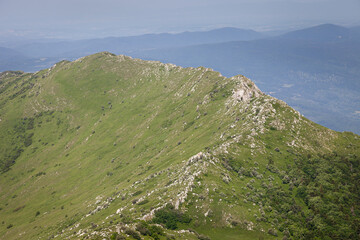 View from Siljak peak on Rtanj mountain of impressive, narrow, rocky mountain ridge and cover by green grass