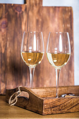 Glass of white wine on vintage wooden table