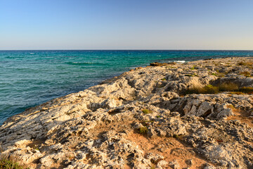 Fototapeta na wymiar rocky beach on the blue sea on a Sunny evening