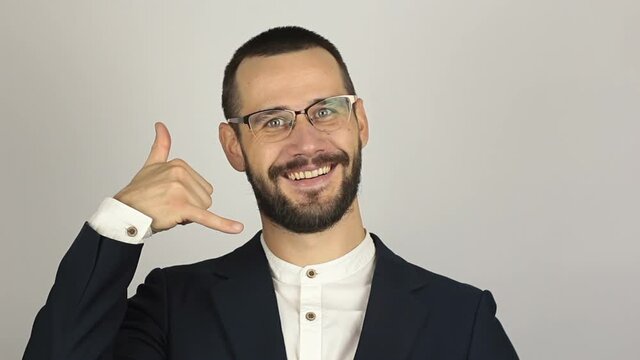 A Young successful businessman asks for a callback and makes a hand gesture.