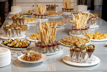 Luxurious catering table.Bacon rolls with delicious filling and sprouted grains. Chicken breast appetizer, with sprouted grains and sauce.