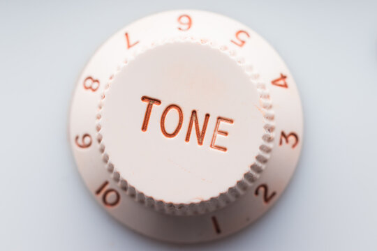 White plastic knob for tone adjustment, selective focus
