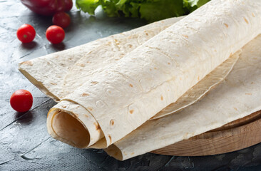 Pita bread is thin on a wooden Board. Armenian thin pita bread on a wooden Board. Pita bread for...