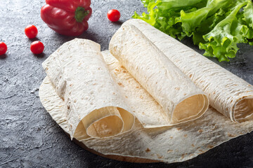 Pita bread is thin on a wooden Board. Armenian thin pita bread on a wooden Board. Pita bread for Shawarma.