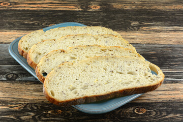 Large slices of round sourdough bread boule on serving plate