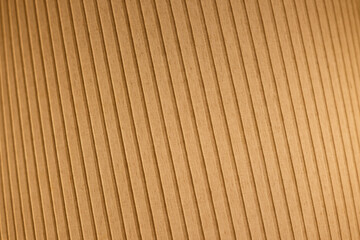 Close-up of an orange and lit fabric surface. Tilted and striped pattern. Abstract high resolution full frame textured background. Shallow depth of field.