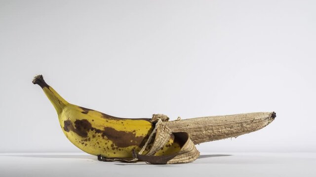 The banana comes to life and rises against a white background. Male Power Concept