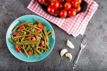 Fresh green cowpea salad with tomato and garlic.