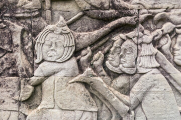 Fototapeta na wymiar Detail of bas relief of khmer warrior on the Bayon, Angkor Thom, Siem Reap