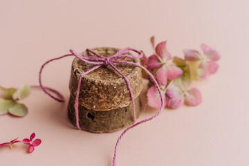 hand-made solid dry shampoos of a round shape on a plain beige background. natural hair cosmetics. soap for handicraft from chamomile and eucalyptus. environmentally friendly products, no waste