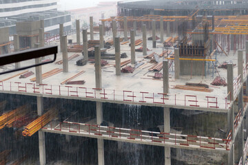 Heavy rain is pouring on the wet construction site