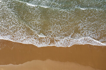 waves crashing on woolacombe beach from above