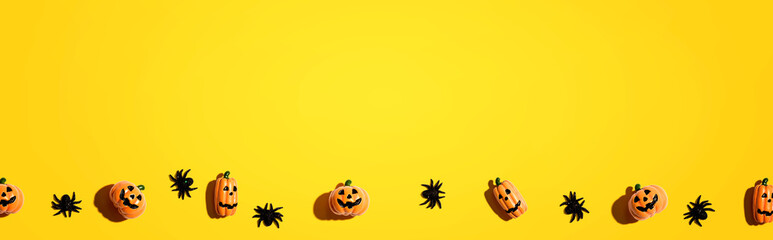 Miniature Halloween pumpkin ghosts with spiders - flat lay