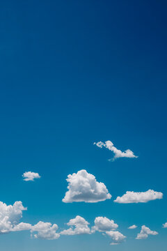 Bright blue sky with white puffy clouds