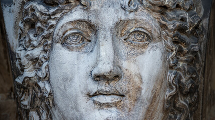 Ancient aged sculpture of beautiful Venetian Renaissance Era woman in Venice, Italy.