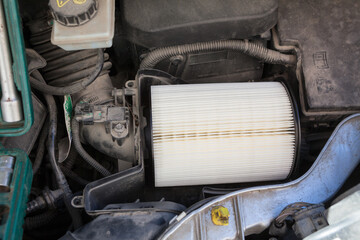 New clean air filter for vehicle engine is mounted in plastic box, close-up view