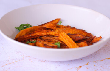 Home made freshness roasted sweet potatoes wedges on marble background