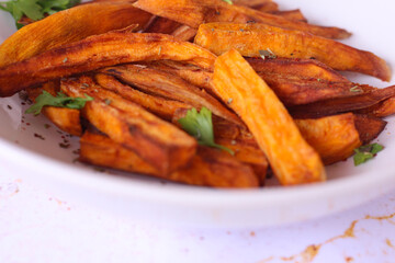 Home made freshness roasted sweet potatoes wedges on marble background