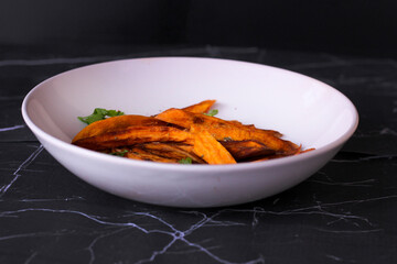 Home made freshness roasted sweet potatoes wedges on marble background