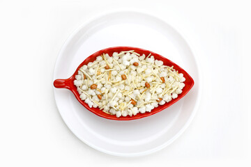 Indian snacks phalhari chiwda in red melamine bowl in white background.