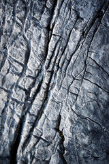 detail of a dark limestone structure with grooves