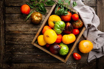 Mixed tomatoes top view. Composition with variety of colorful fresh organic tomatoes.