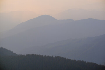 Summer misty evening mountain tops silhouettes. Marmaros, Carpathian, Ukraine.