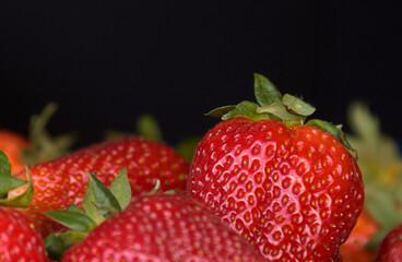 juicy strawberry close-up on a black background