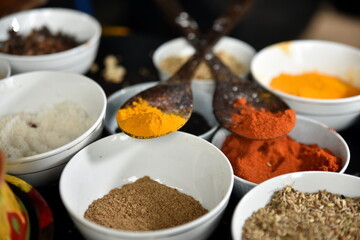 Variety of spices and herbs on kitchen wooden table