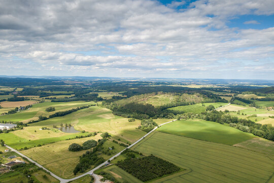 agricultural landscape with a small town in the background photographed from above