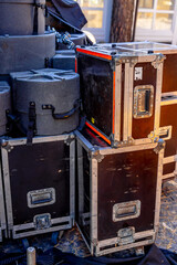 Fototapeta na wymiar Musical instrument cases. Stand one at another outdoor. Equipment for concert.