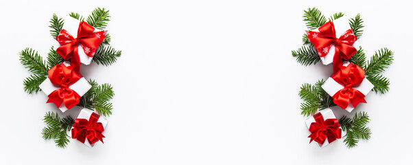 Merry Christmas and Happy Holidays greeting card, frame, banner. New Year. Noel. Red Christmas ornaments and gift on white background top view. Winter xmas holiday theme. Flat lay	