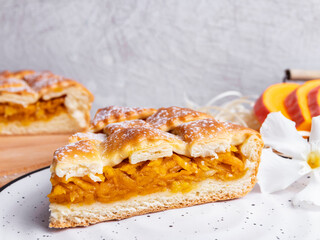 Delicious homemade pie tart with pumpkin cabbage filling, close up, round, cut piece