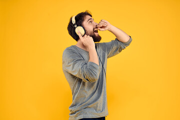 Man with headphones music lifestyle lifestyle technology yellow background