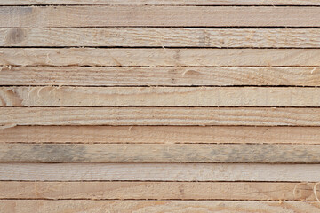 Construction material for background and texture. Wood products, planks, lining, boards for construction works in material store storage. Timber industry objects.