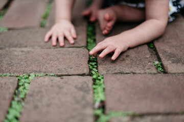 Child's hands exploring and feeling the ground