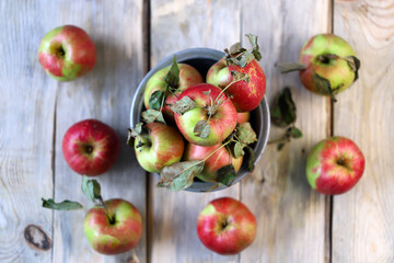 Fresh apples in a bowl on a wooden surface. Harvest apples.