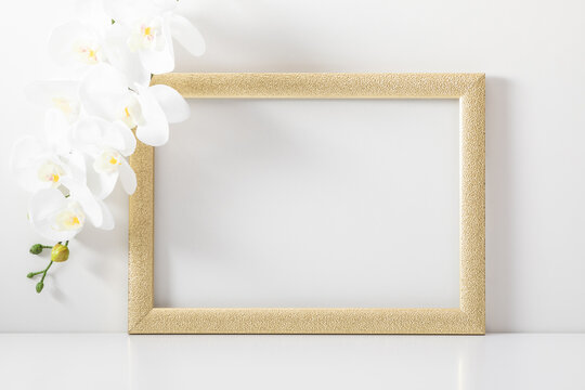 Beautiful flowers composition. White orchid, front view blank mock up of photo frame on white background. White orchids, greeting card.
