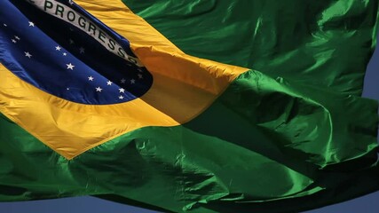 Brazilian flag blowing in the wind. Brazil, real video, blue sky