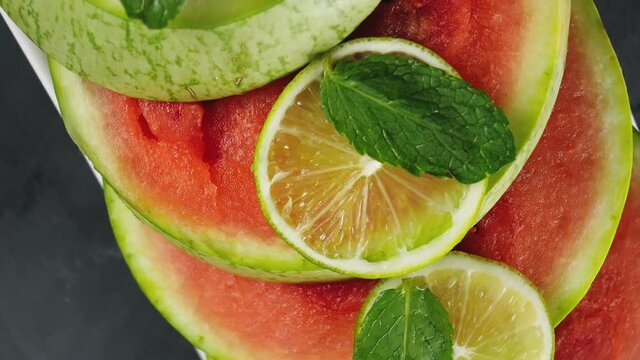 Fresh fruits. Fruit mix, watermelon and lime. Mft leaves. Studio photography of various fruits on a white table. Organic healthy fruit assortment. Assortment of fresh fruits.