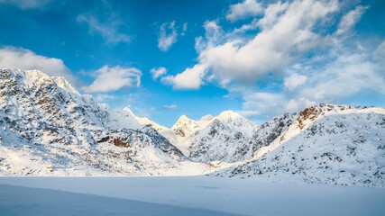 Fabulous winter scenery with lots of snow  and snowy  mountain peaks near Bostad.