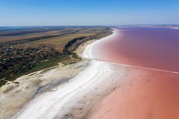 Aerial drone top down photo of a natural pink lake Kuyalnik in Odessa, Ukraine. Lake naturally turns pink due to salts and small crustacean Artemia in the water. This miracle is rare occurrence.