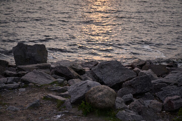 rocky beach by the water at sunset or dawn