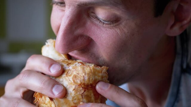 Hungry Man Takes a Bite of Delicious and Crispy Shawarma Close-up. Slow Motion.
