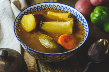 Latin American vegetable soup with ingredients carrot, chayote, sweet potato, green banana pepper