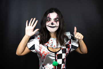 woman in a halloween clown costume over isolated black background showing and pointing up with fingers number six while smiling confident and happy