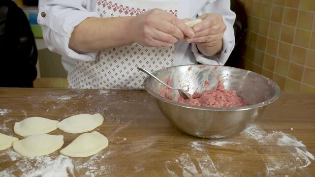 Modeling of dumplings chebureks minced dough hands cook master handmade meat cooking