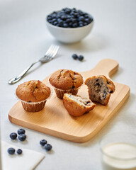 blueberry muffins on a wooden board