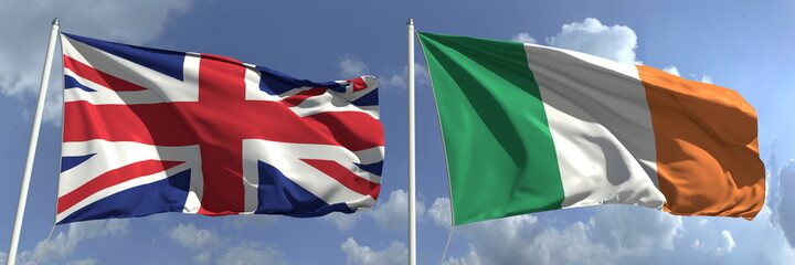 Waving flags of Great Britain and Ireland on flagpoles, 3d rendering